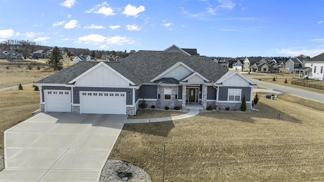 view of front of property with driveway, stone siding, roof with shingles, board and batten siding, and a garage