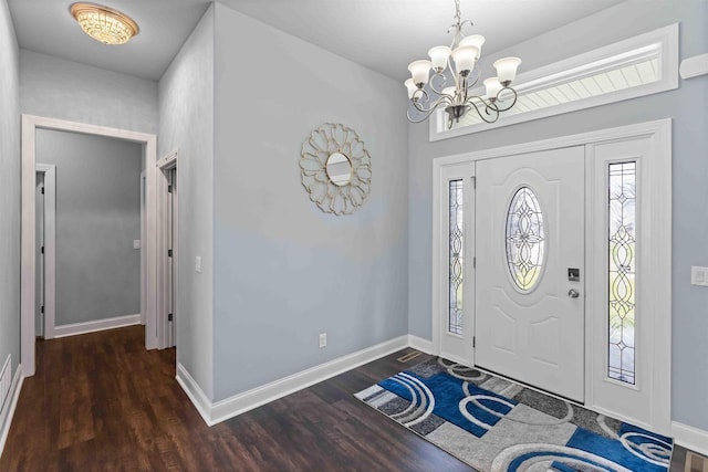 foyer with a notable chandelier, baseboards, and wood finished floors