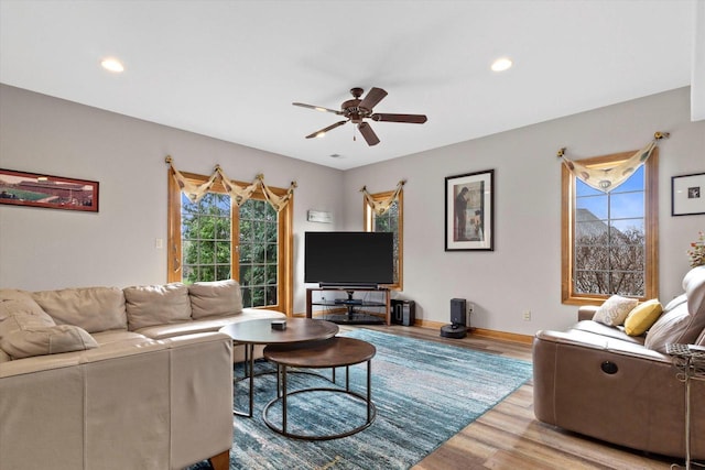 living room featuring ceiling fan, baseboards, wood finished floors, and recessed lighting