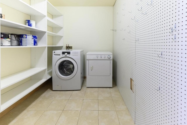 laundry room featuring laundry area, tile patterned flooring, and independent washer and dryer