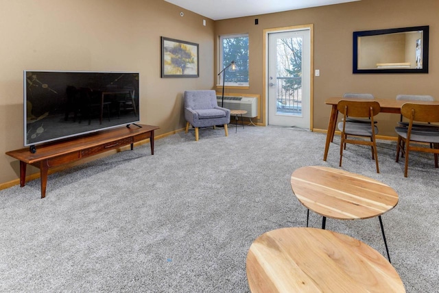 living area featuring carpet floors and baseboards