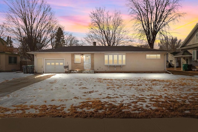 view of front of house with a chimney and an attached garage