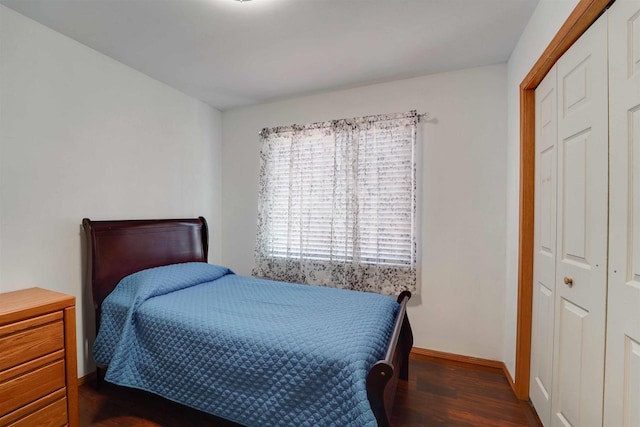 bedroom featuring baseboards and wood finished floors