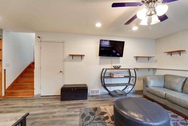 living room featuring recessed lighting, wood finished floors, visible vents, a ceiling fan, and stairway