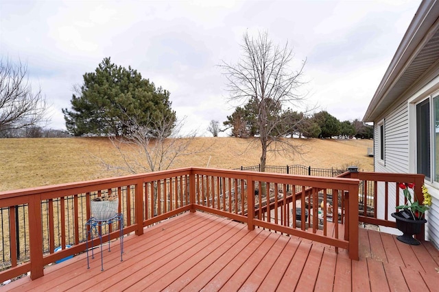 wooden deck featuring a yard