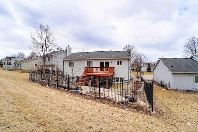 back of property featuring a chimney, a patio area, fence, and a deck