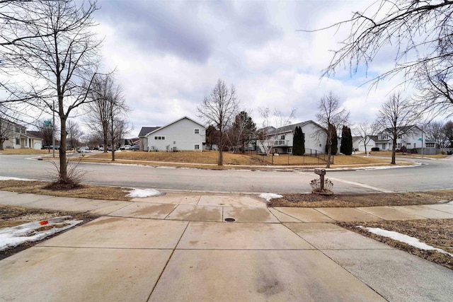 view of road with a residential view and sidewalks