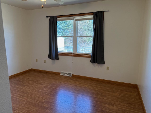 1080 Jaystone Ter, Waterloo, WI 53594 - unfurnished room with visible vents, wood finished floors, baseboards, and ceiling fan