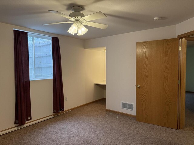 1080 Jaystone Ter, Waterloo, WI 53594 - unfurnished bedroom with carpet flooring, a ceiling fan, and baseboards