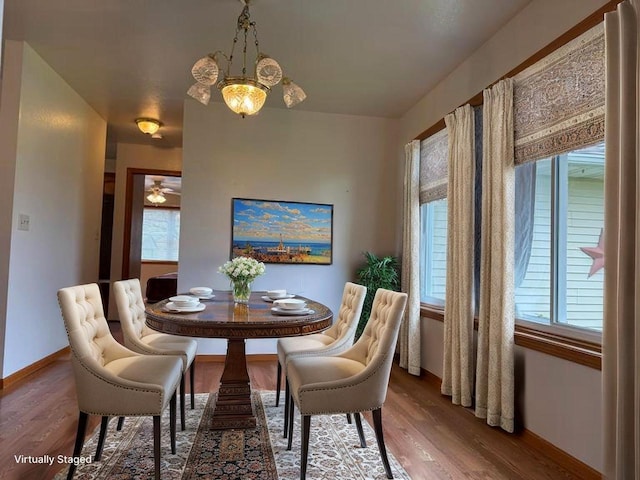 1080 Jaystone Ter, Waterloo, WI 53594 - dining space with wood finished floors, baseboards, and a chandelier