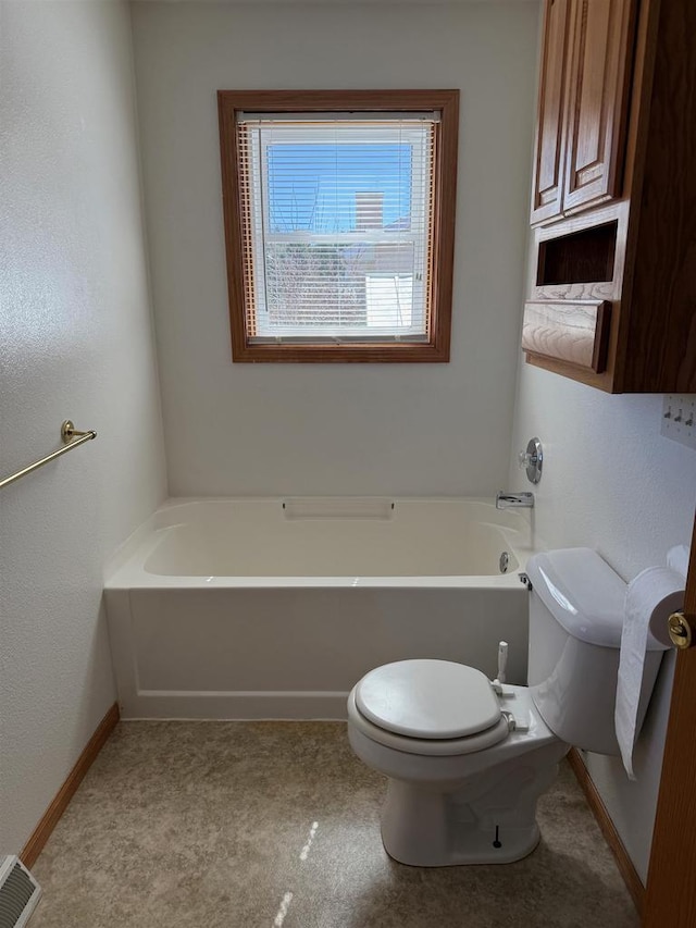 1080 Jaystone Ter, Waterloo, WI 53594 - bathroom with toilet, baseboards, and a bath