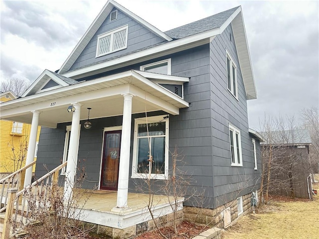 view of front of house with covered porch and roof with shingles