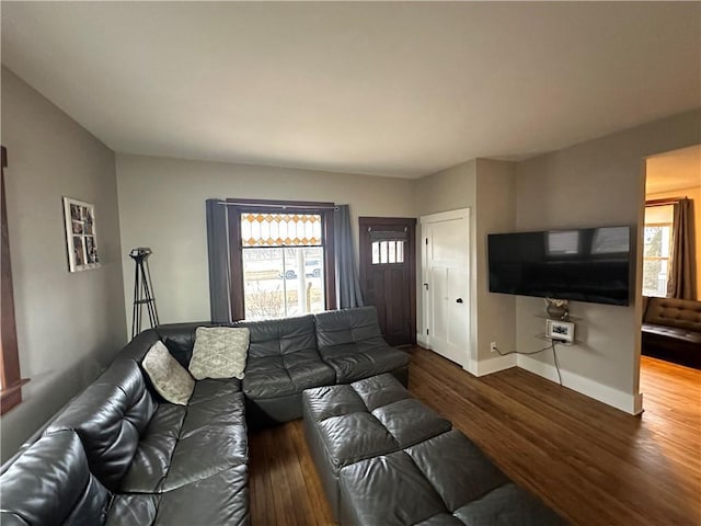 living area featuring wood finished floors and baseboards