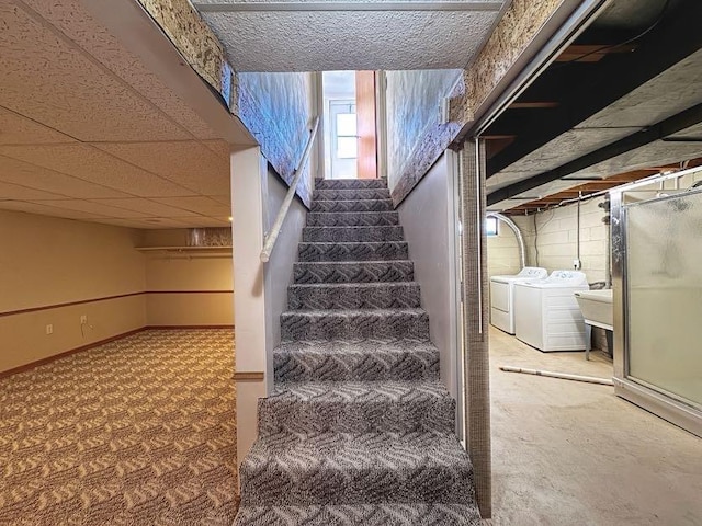 stairway featuring independent washer and dryer and baseboards