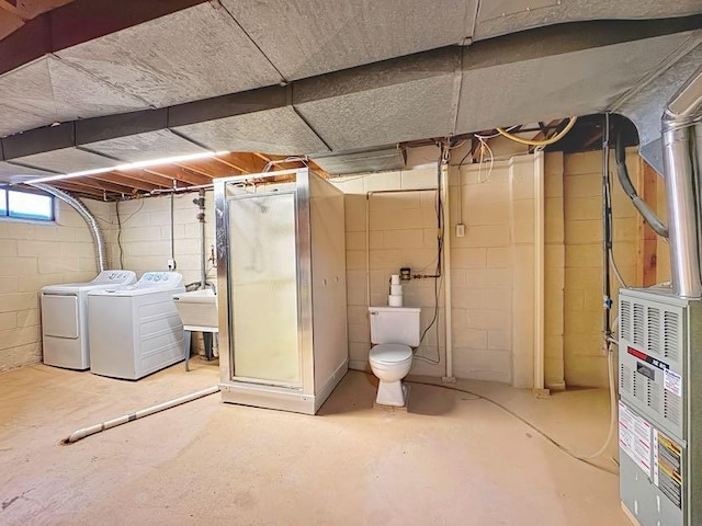 basement featuring separate washer and dryer and a sink