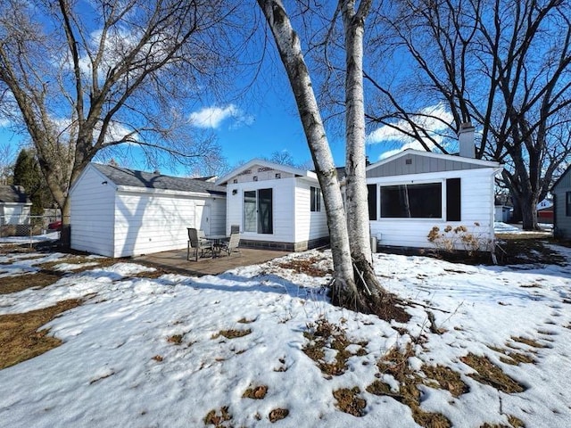 view of front of home featuring a patio area and a chimney