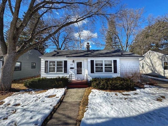 view of front of home with a garage and a chimney