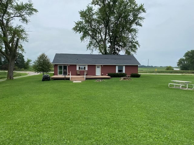 rear view of property with a deck and a lawn