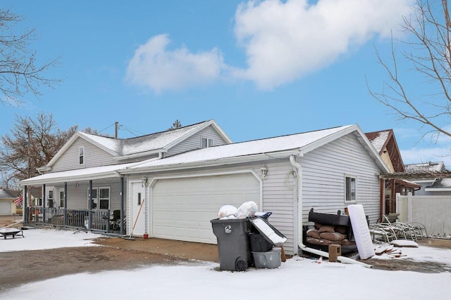 exterior space with a garage, fence, and a porch