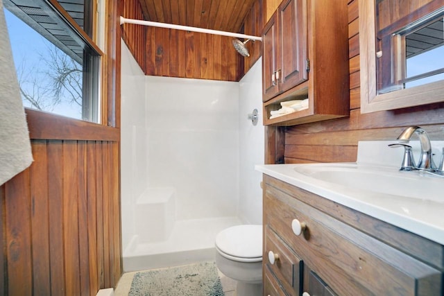 bathroom with wooden ceiling, a shower stall, toilet, and vanity