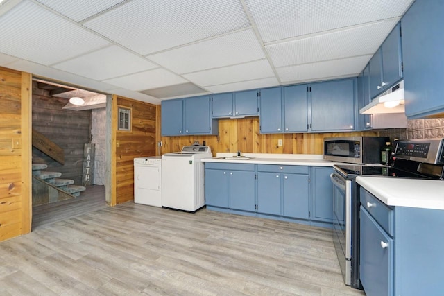 kitchen featuring blue cabinets, stainless steel appliances, light wood-type flooring, under cabinet range hood, and separate washer and dryer