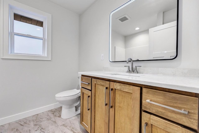 bathroom with marble finish floor, visible vents, toilet, vanity, and baseboards