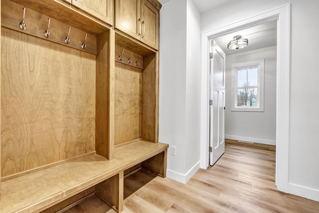 mudroom featuring baseboards and light wood finished floors