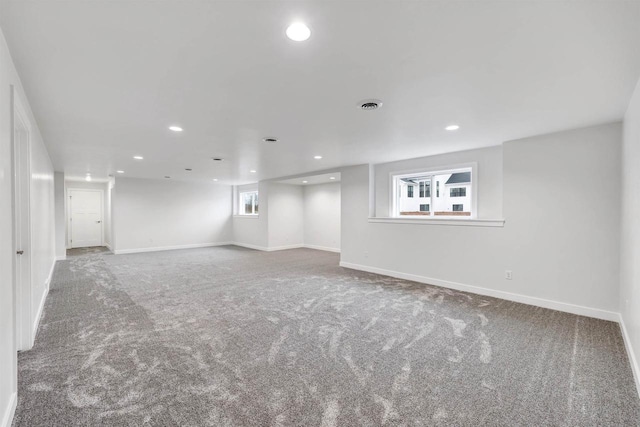 below grade area featuring recessed lighting, carpet flooring, visible vents, and baseboards