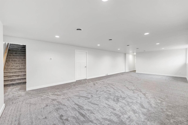 spare room with recessed lighting, baseboards, carpet, and stairs