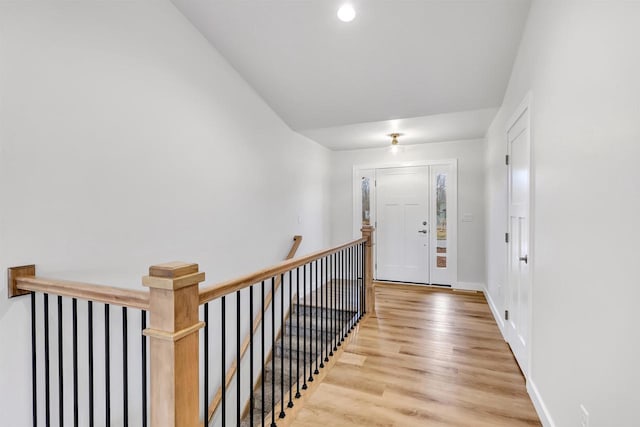 entryway with light wood-style flooring and baseboards