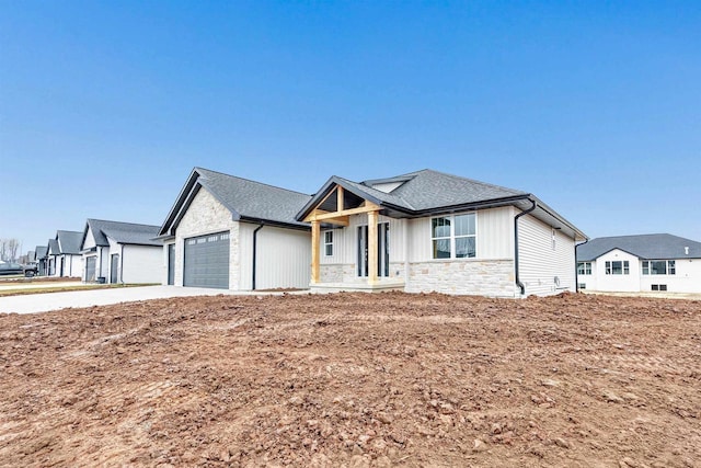 modern farmhouse style home featuring an attached garage, stone siding, concrete driveway, roof with shingles, and board and batten siding