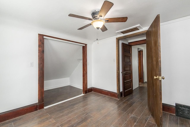 empty room with a ceiling fan, dark wood finished floors, visible vents, and baseboards