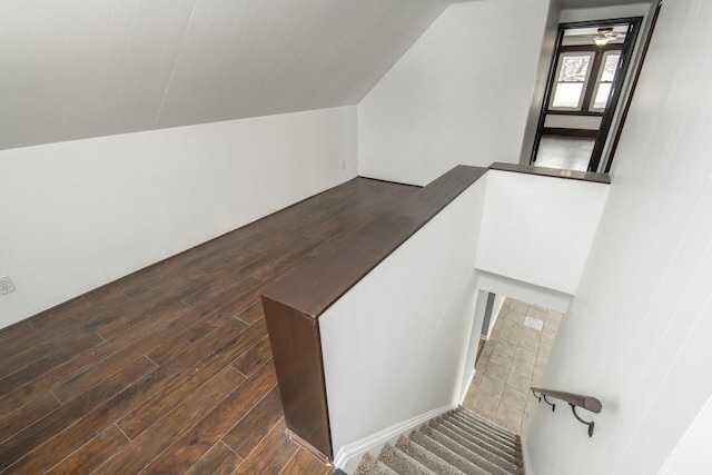 stairway with vaulted ceiling and wood finished floors