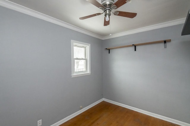 spare room featuring ornamental molding, a ceiling fan, baseboards, and wood finished floors