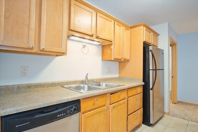 kitchen featuring light tile patterned floors, stainless steel appliances, a sink, baseboards, and light countertops