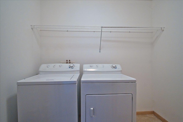 laundry room featuring laundry area, independent washer and dryer, and baseboards