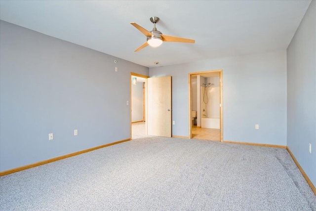 unfurnished bedroom featuring a ceiling fan, carpet flooring, connected bathroom, and baseboards