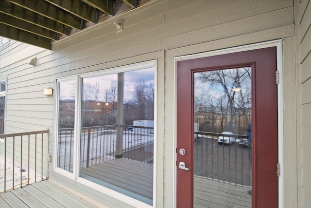 view of exterior entry with a balcony