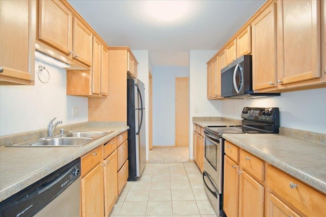 kitchen with stainless steel appliances, light brown cabinetry, a sink, and light tile patterned floors