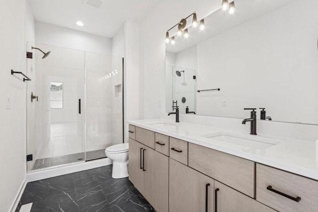 full bath with a stall shower, a sink, toilet, and double vanity
