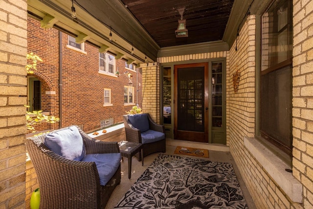 entrance to property featuring brick siding and covered porch