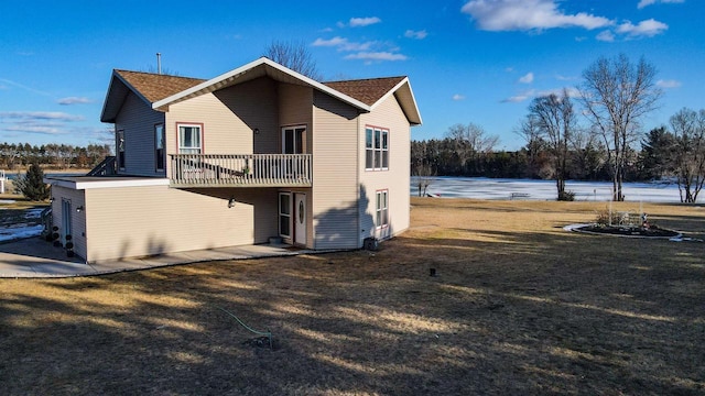 rear view of property featuring a yard