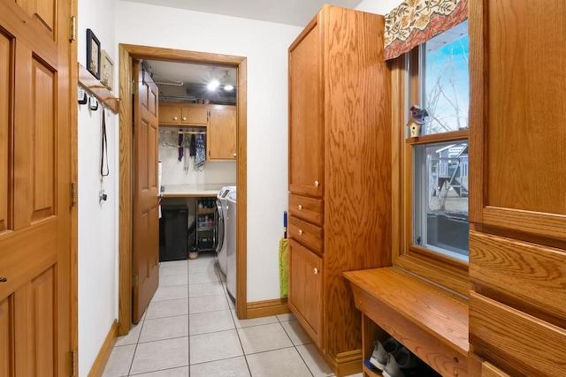 mudroom featuring light tile patterned floors and washer / clothes dryer