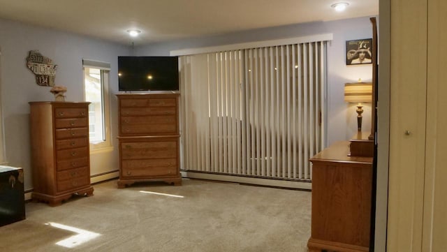 carpeted bedroom with a baseboard radiator