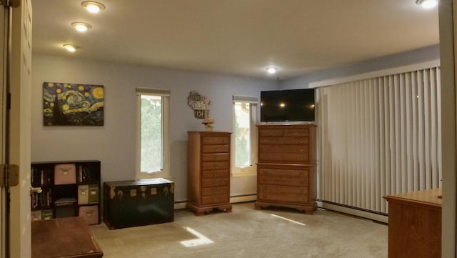 living area with carpet floors and baseboard heating