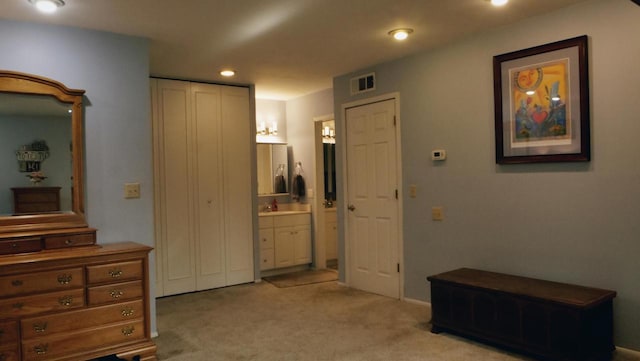 corridor featuring recessed lighting, visible vents, and light colored carpet