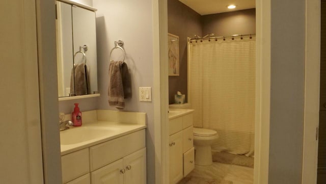 full bath featuring toilet, a shower with shower curtain, and vanity