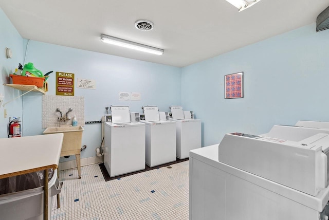 common laundry area with washer and dryer and visible vents