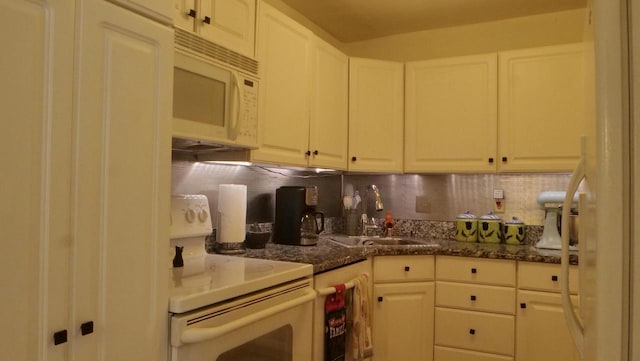 kitchen featuring white cabinets, white appliances, decorative backsplash, and a sink