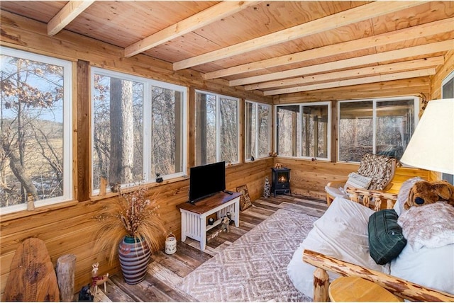 sunroom with wooden ceiling, beamed ceiling, and a healthy amount of sunlight